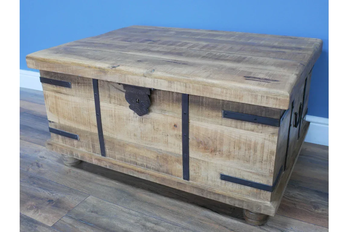 Rustic wooden storage chest with black metal accents on wood floor