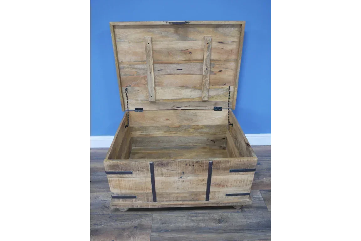 Solid wood storage chest with open lid and metal strap accents on wooden floor