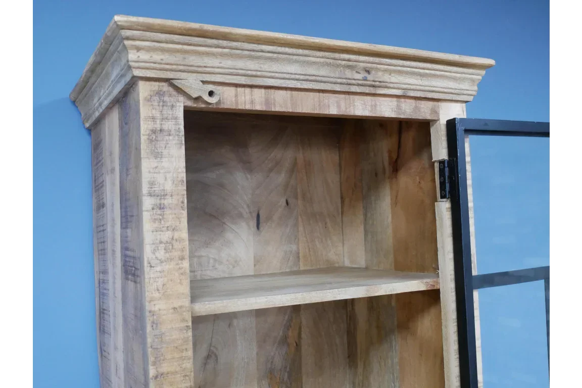 Rustic wooden cabinet with glass door and single shelf against blue wall