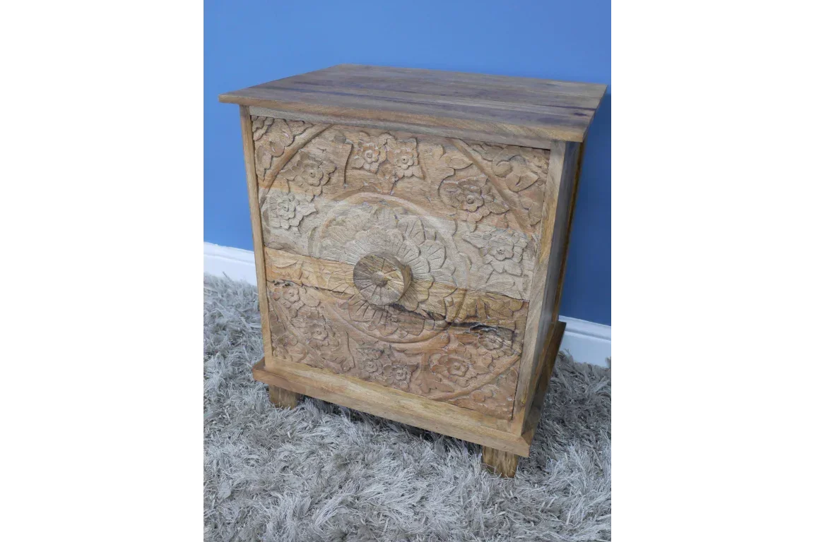 Carved wood bedside table with floral details, two drawers, natural finish on grey rug