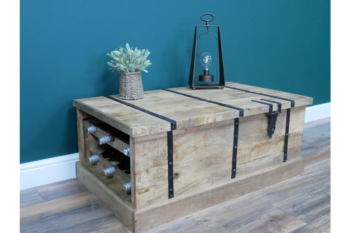 Rustic wooden coffee table with iron accents and built-in wine rack on wooden floor
