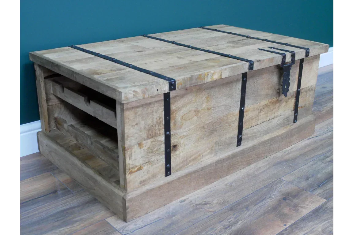 Rustic wooden storage coffee table with black metal straps and side shelving on wooden floor