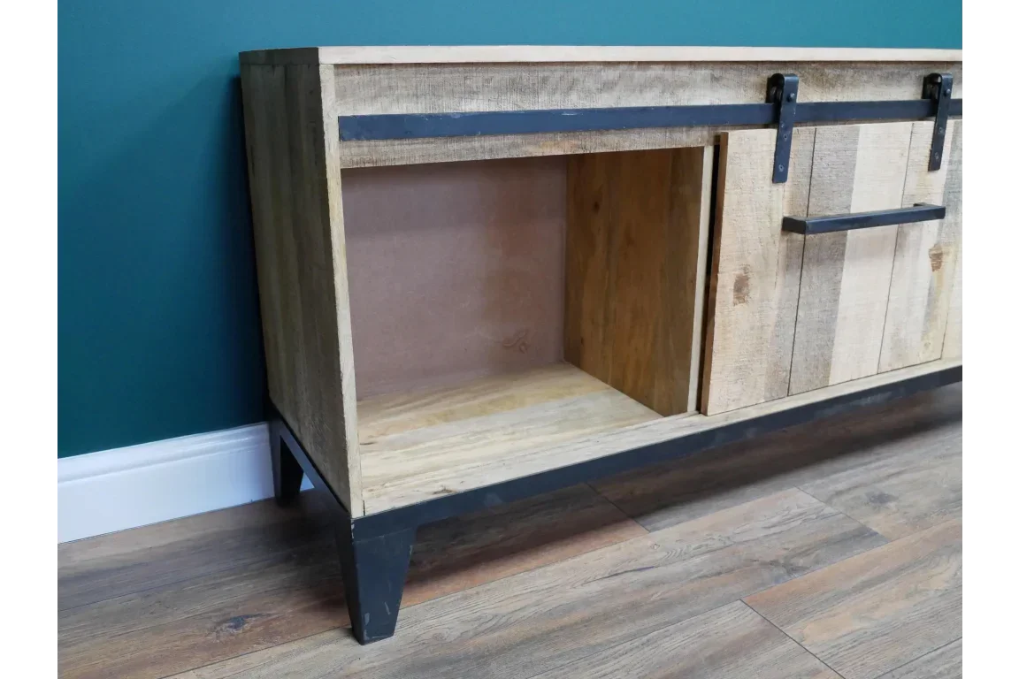 Rustic wood sideboard with sliding barn door and black metal frame on wood flooring