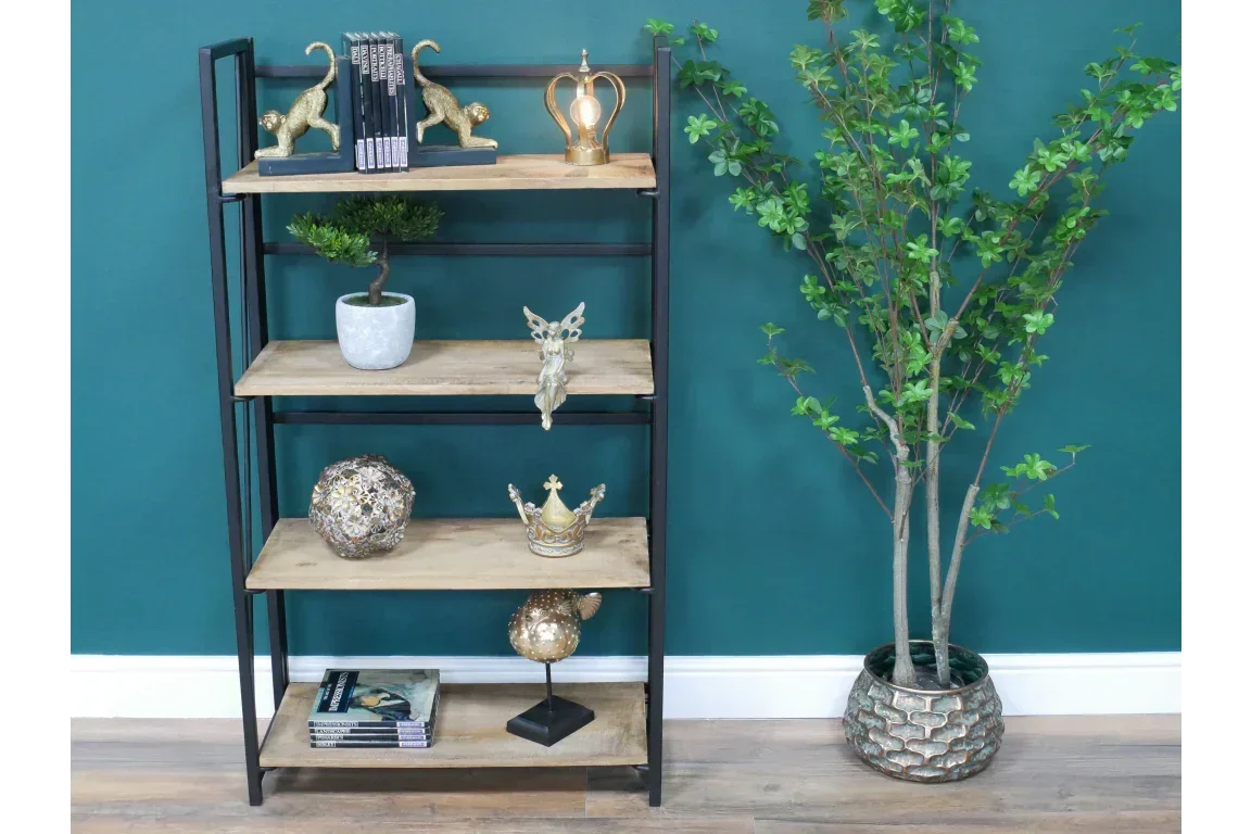 Wood and metal shelving unit with decor beside artificial potted plant on wooden floor