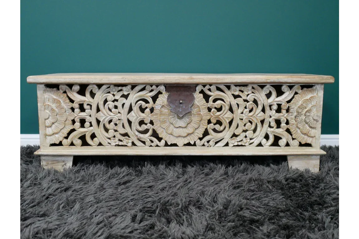 Wooden storage chest with ornate hand-carved floral design on front panel