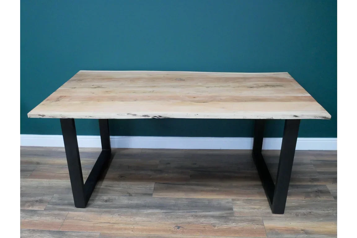 Modern wooden dining table with black metal legs on hardwood floor