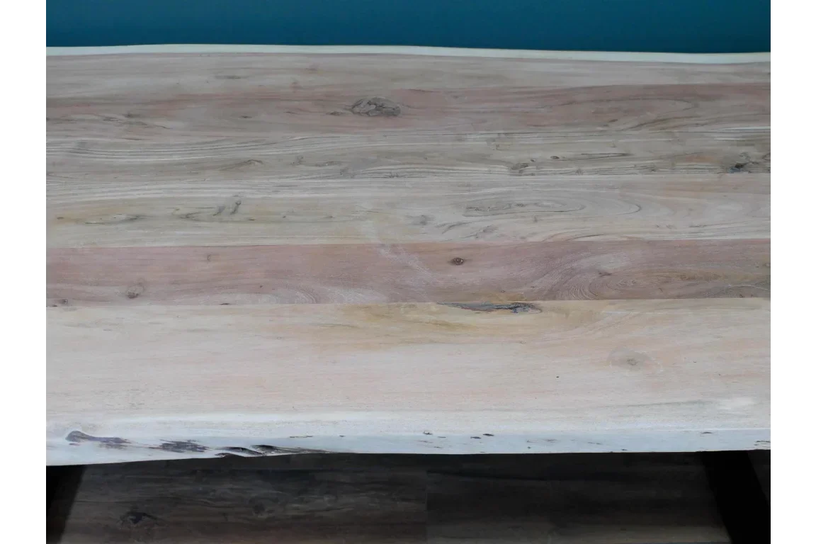 Solid wood dining table top with natural grain and light finish, front angled view