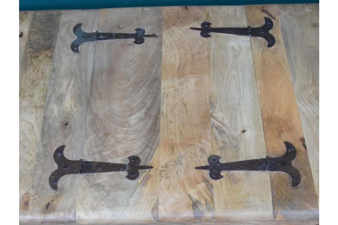 Rustic wooden storage chest lid with black metal hinges, natural grain finish visible