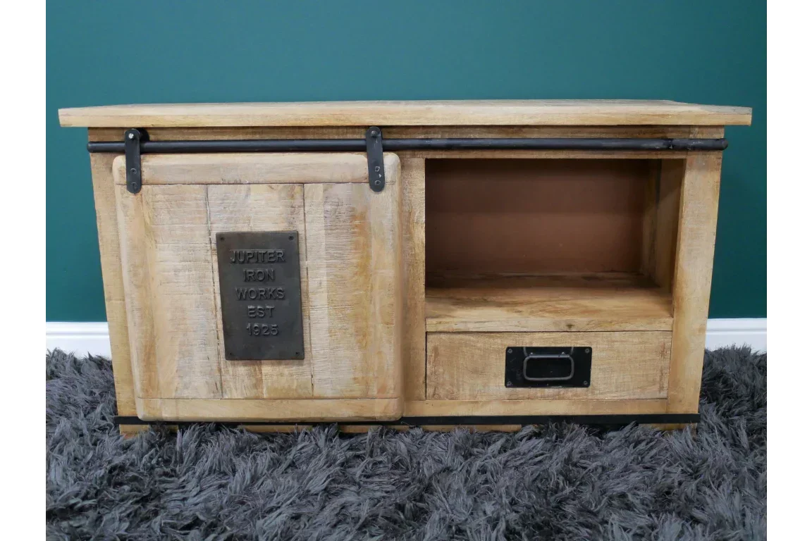 Rustic wooden TV unit with sliding barn door, open shelf, and drawer on grey rug
