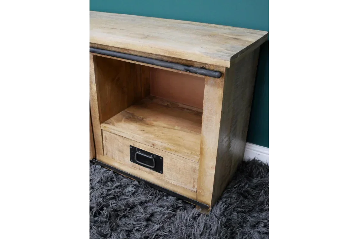 Wooden side table with open shelf and drawer, metal handle detail, on grey rug