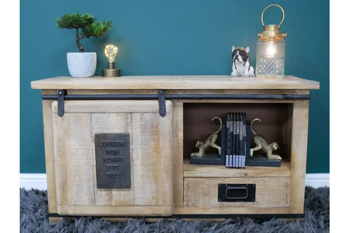 Rustic wooden TV unit with sliding barn door, display shelf, and decorative accessories