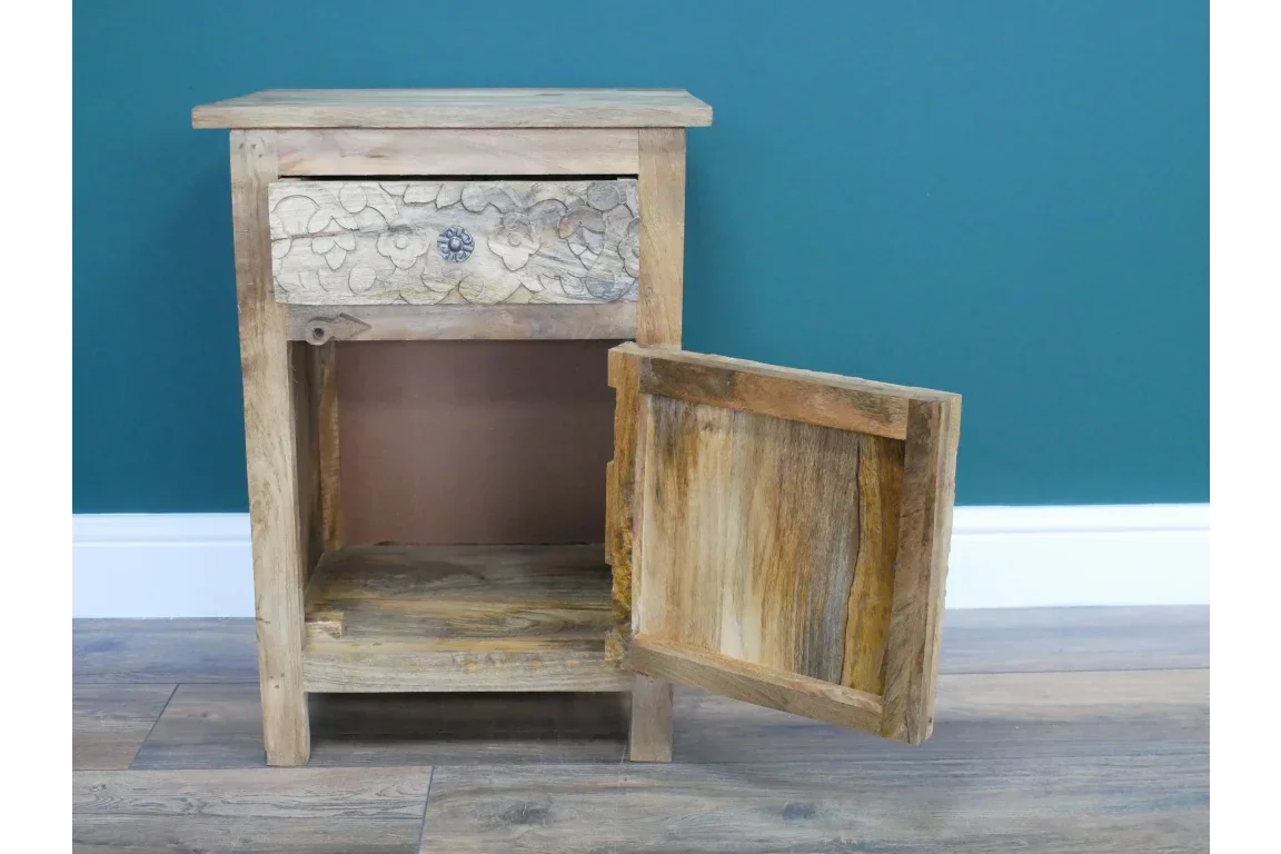 Mango wood bedside cabinet with carved drawer front and open door on wood floor