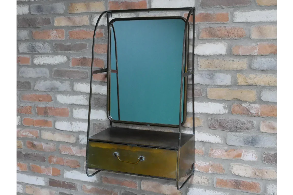 Industrial wall-mounted metal mirror with storage drawer against brick wall
