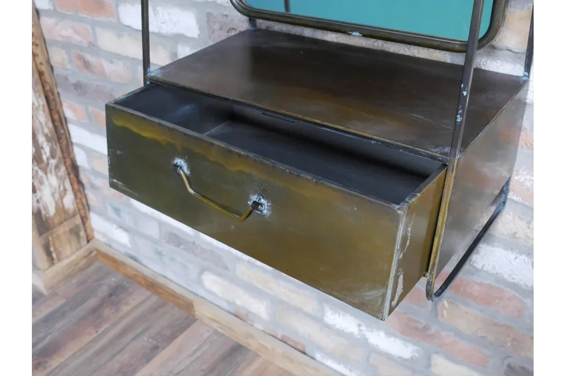 Industrial metal drawer unit with open storage shelf mounted on brick wall