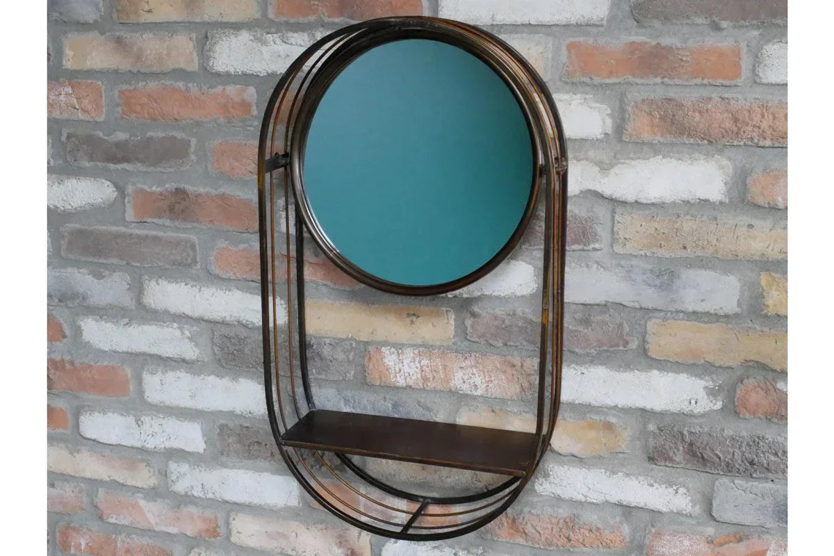 Metal wall mirror with round frame and integrated shelf against exposed brick wall