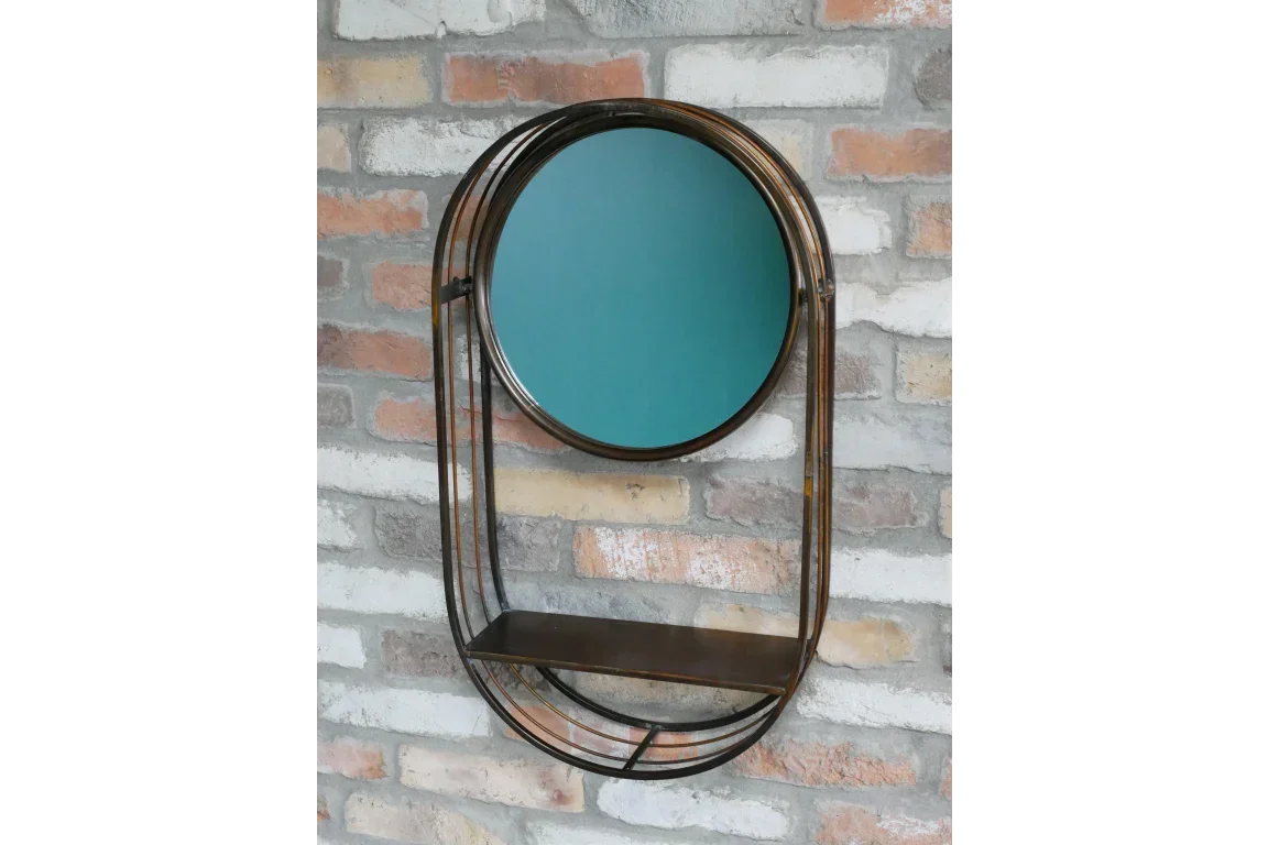 Round wall mirror with metal frame and shelf against exposed brick wall
