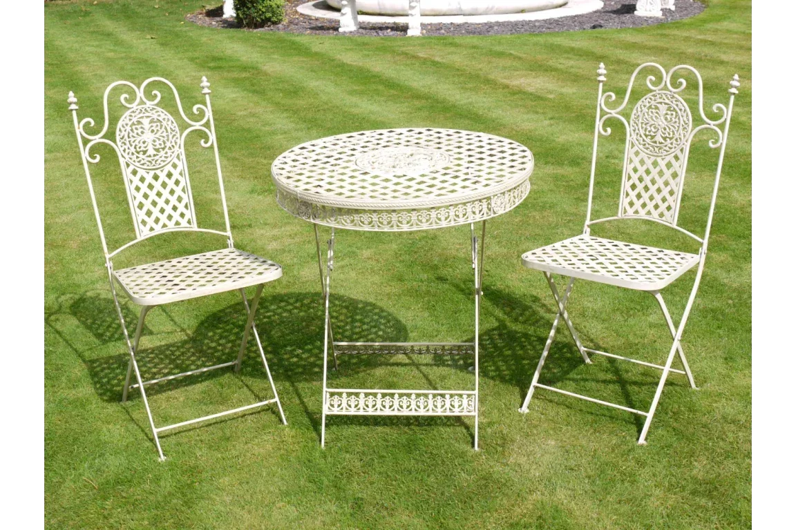 Cream metal garden bistro set with round table and two chairs on lawn