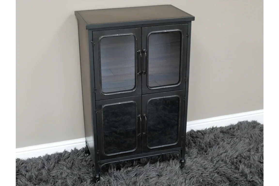 Black metal storage cabinet with glass doors and handles on grey rug