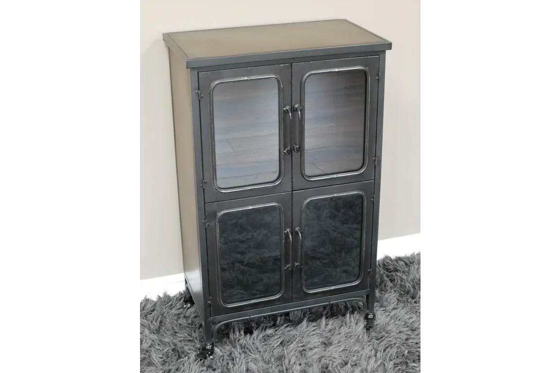 Black metal storage cabinet with glass doors on four legs, placed on grey shag rug