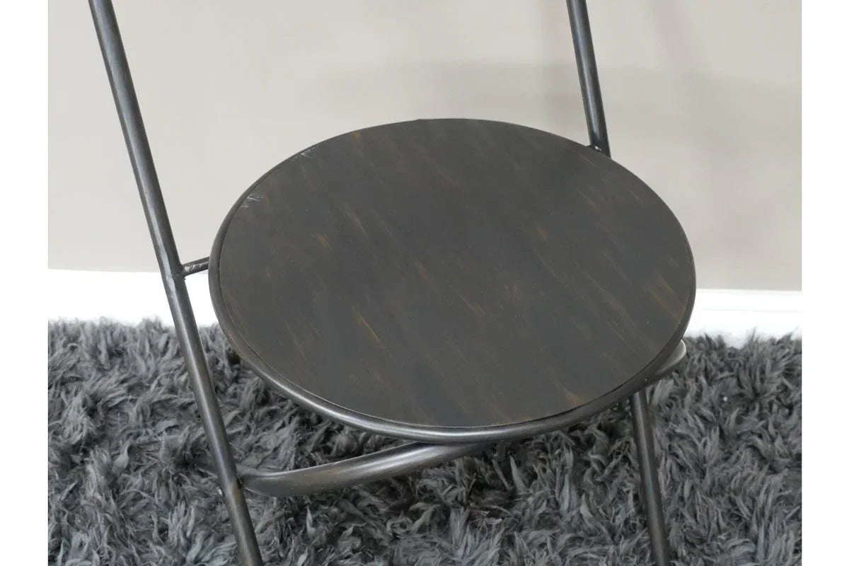 Black metal folding chair with round wooden seat on grey shaggy rug