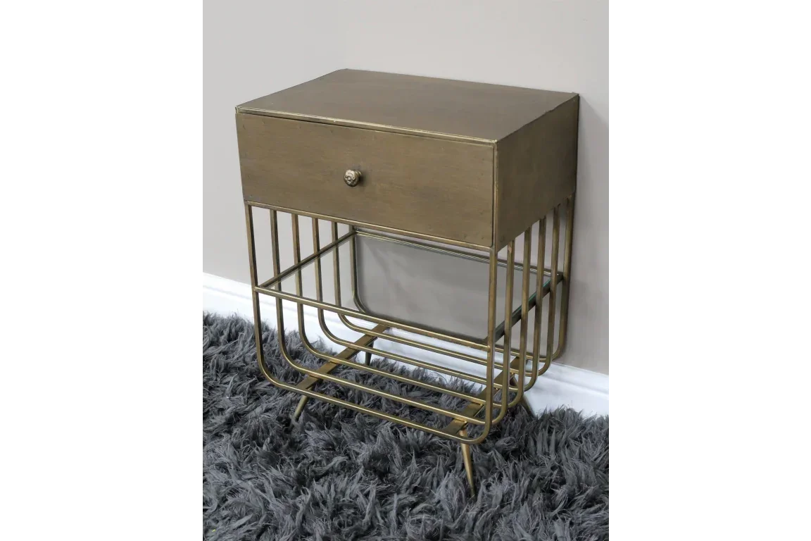 Gold metal bedside table with single drawer and lower storage shelf on grey rug
