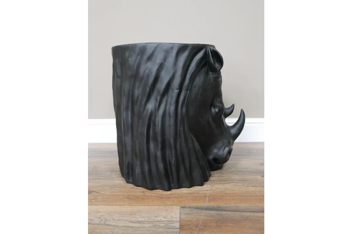 black rhino head side table with detailed horn and textured finish on wooden floor