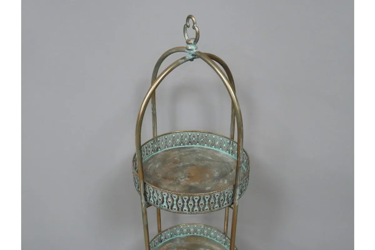 Antique brass decorative tray stand with two round patterned shelves and arched handle