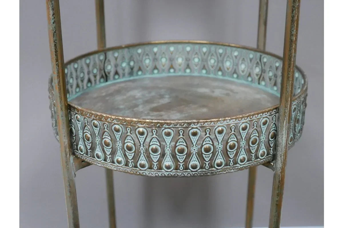 Round metal side table with ornate blue and gold embossed detailing and distressed finish