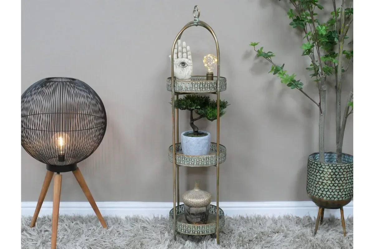 Round wire floor lamp and metal plant stand with potted bonsai and decor on shaggy rug