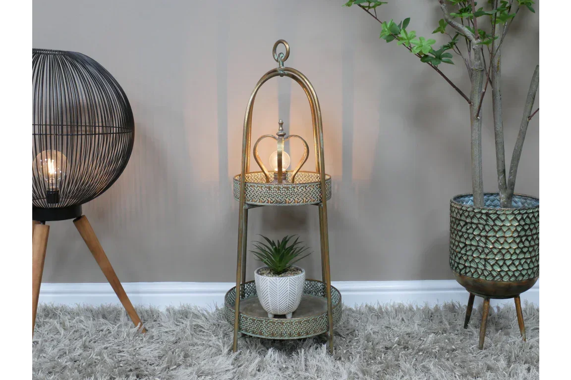 Antique gold tiered lamp table with decorative tray shelves and potted plant on grey rug