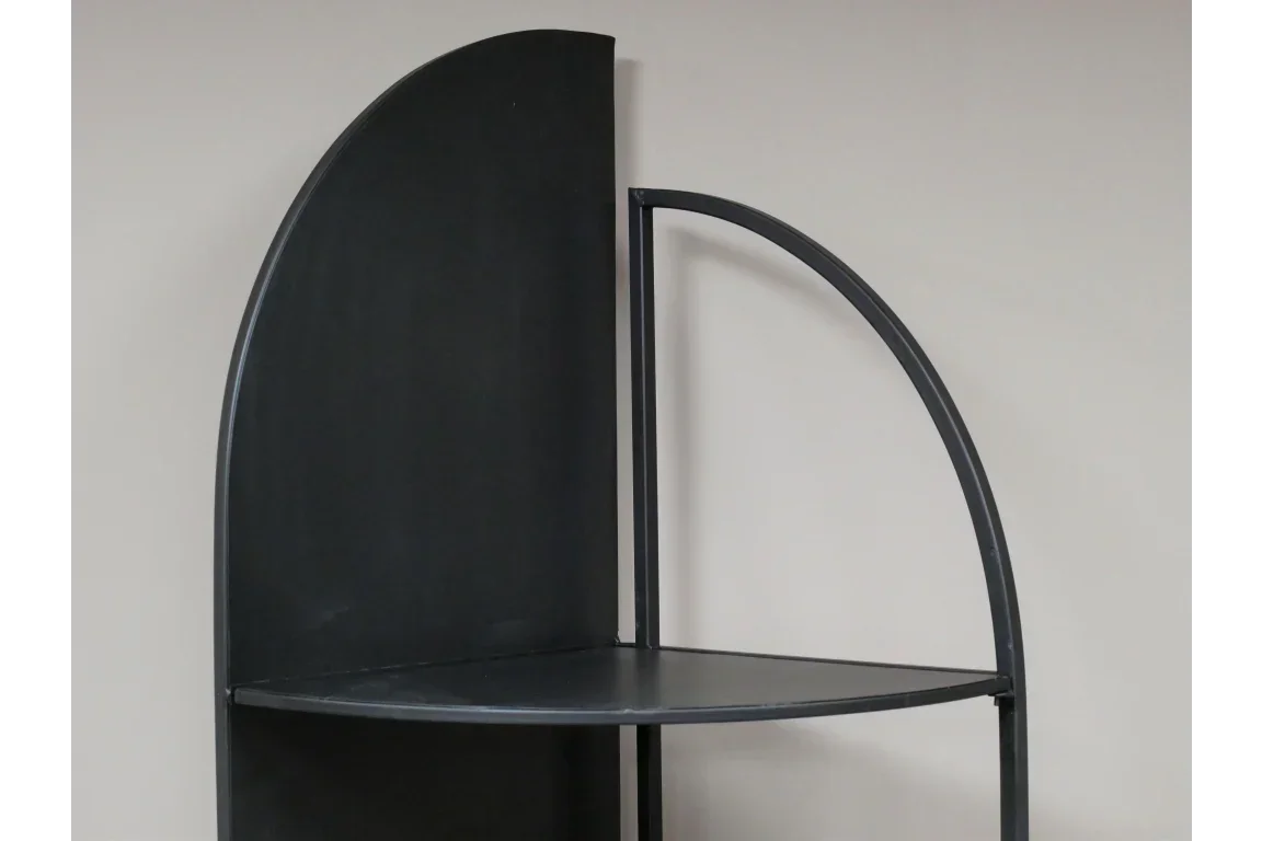 black metal corner shelf unit with curved frame against neutral wall
