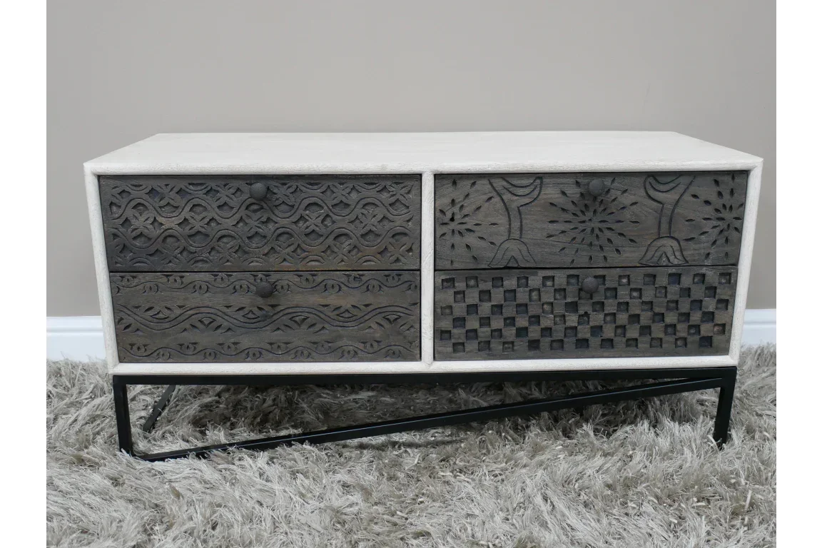 Wooden sideboard with four carved drawers on black metal legs, textured patterns visible