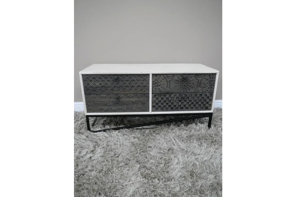 Modern sideboard with patterned front drawers and black metal legs on grey rug
