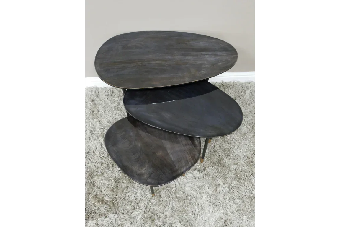 Set of three black wood nesting tables with rounded tops on grey rug