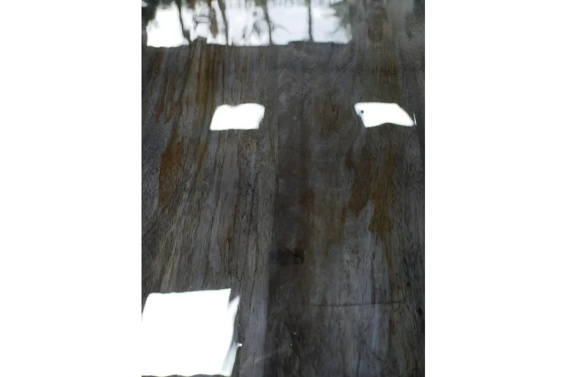 Close-up of polished wooden table top with natural wood grain and glossy finish