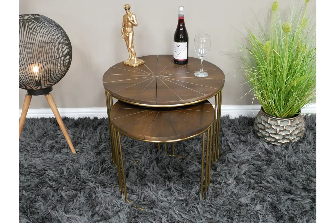 Round wood nest of tables with gold metal legs in living room setup on grey rug