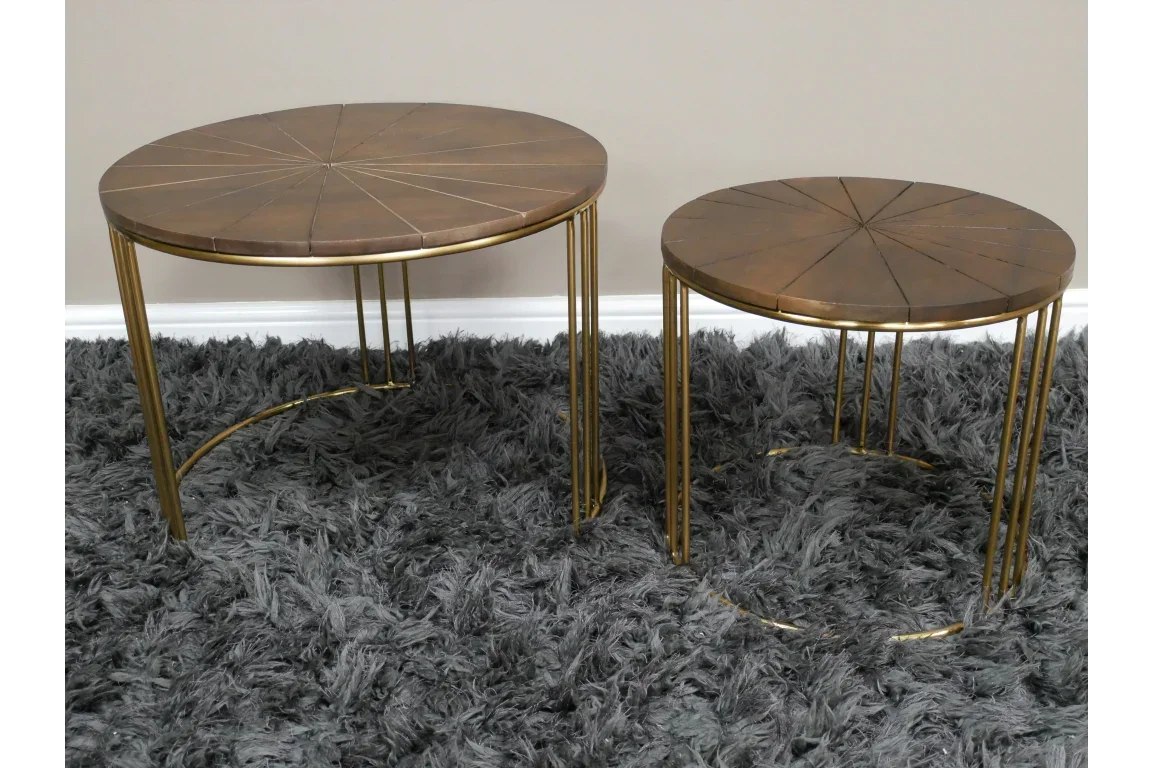 Round nesting coffee tables with brown tops and gold metal legs on a grey shag rug