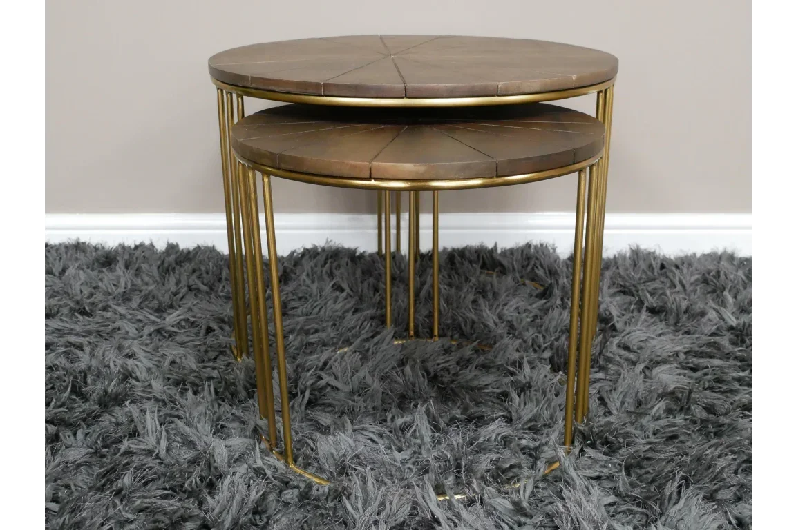 Round nesting coffee tables with wood tops and gold metal legs on grey shaggy rug