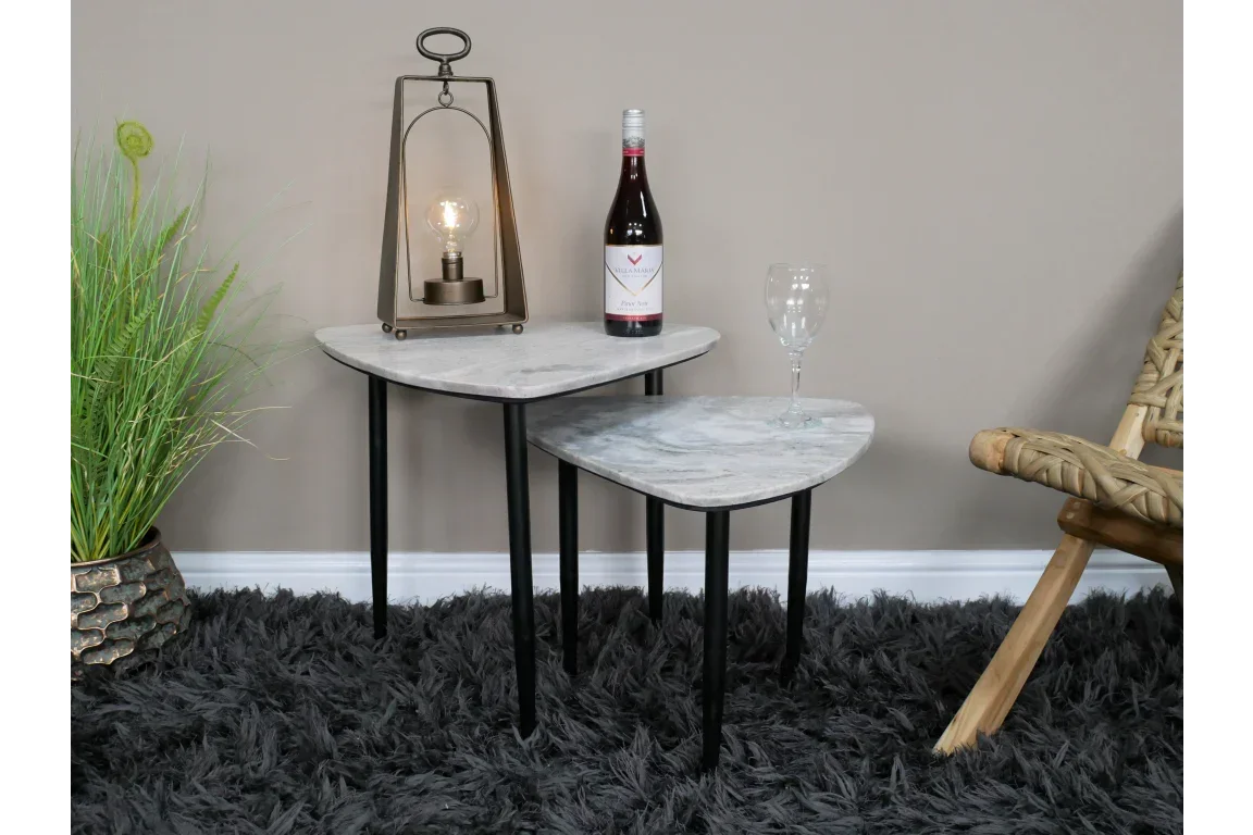 Set of two marble top nesting side tables with black legs on shaggy grey rug