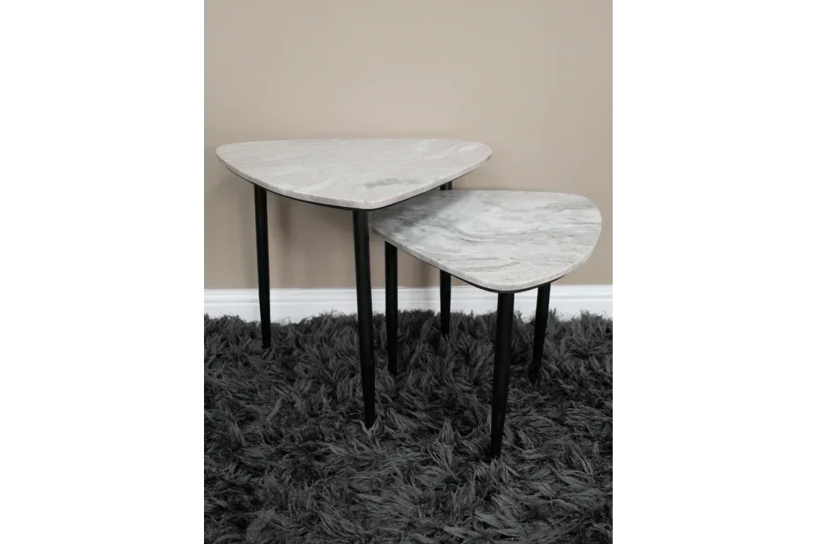 Set of two marble top nesting tables with black legs on a grey shaggy rug