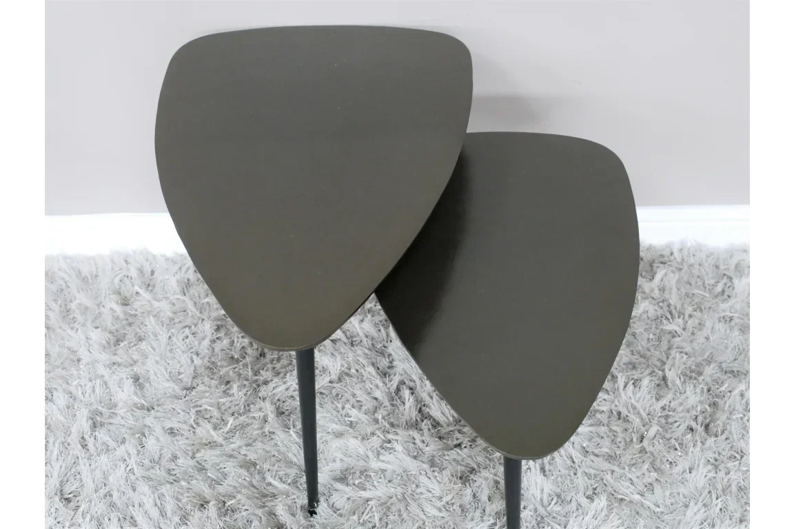 Set of two nesting coffee tables with dark tops and black legs on a grey rug