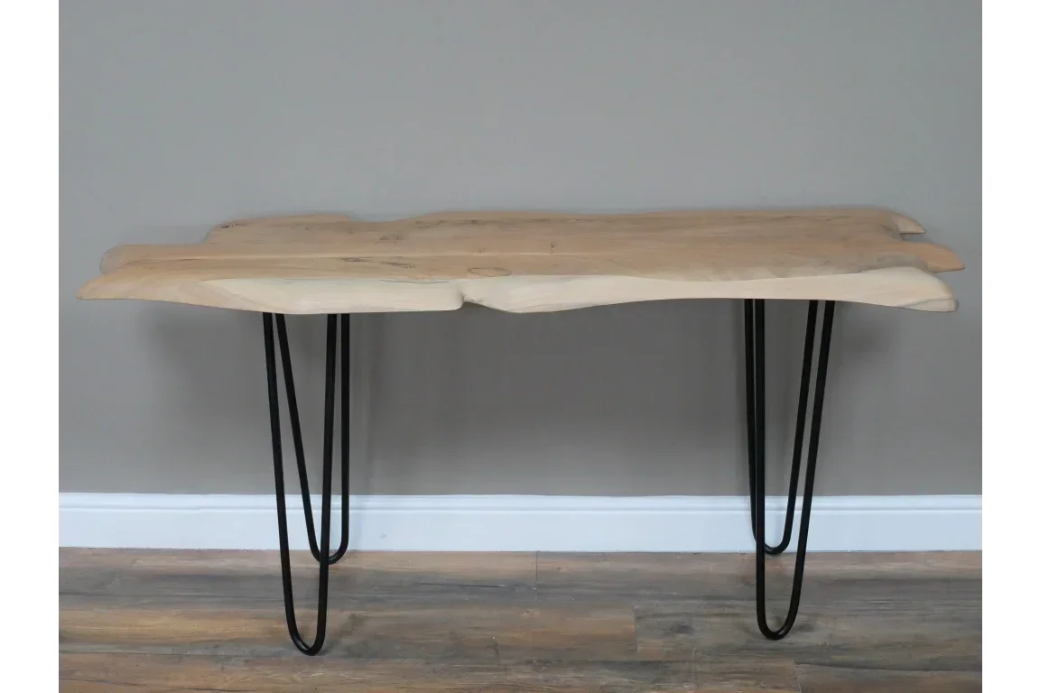 Live edge wooden console table with black metal hairpin legs against grey wall