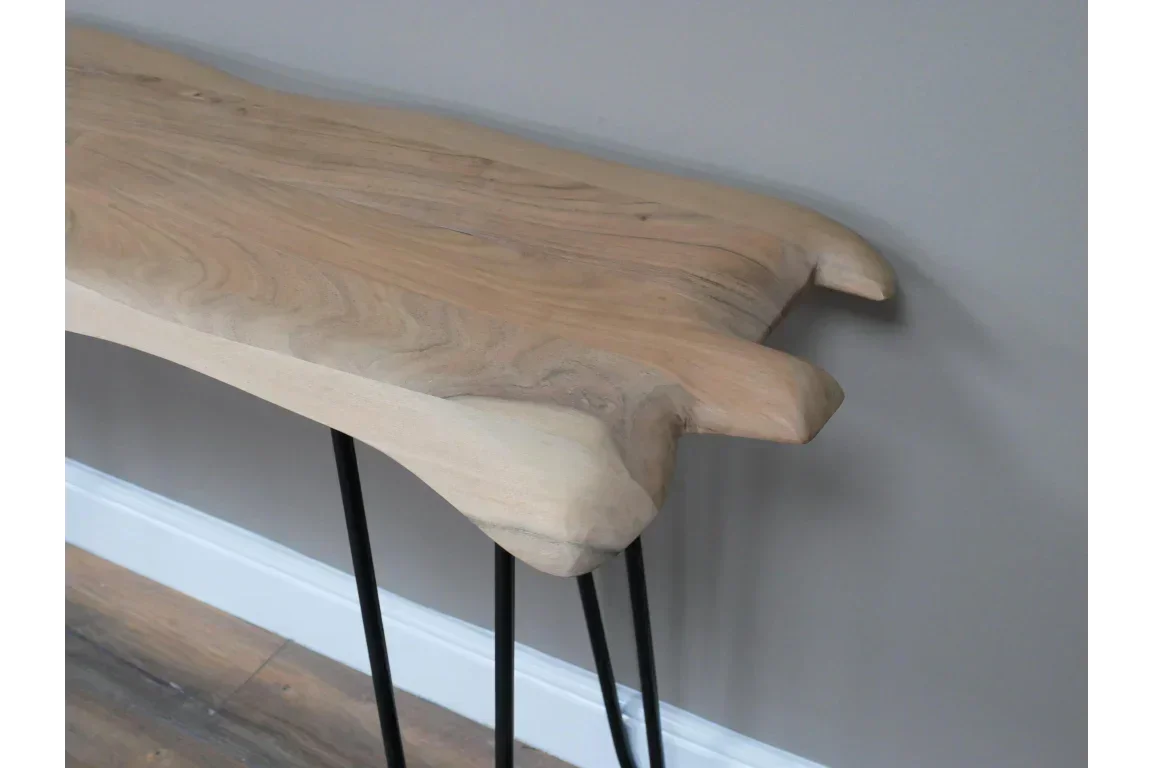 Live edge wooden console table with black metal legs against grey wall