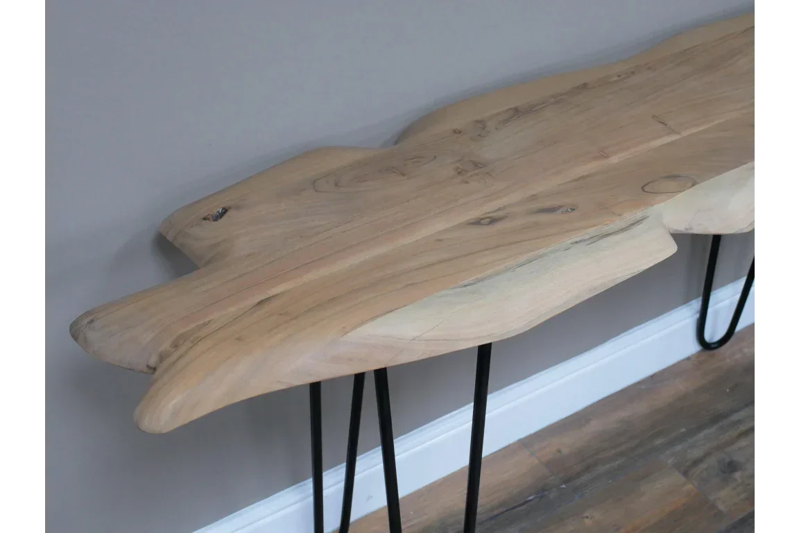 Live edge wood console table with black metal hairpin legs against grey wall