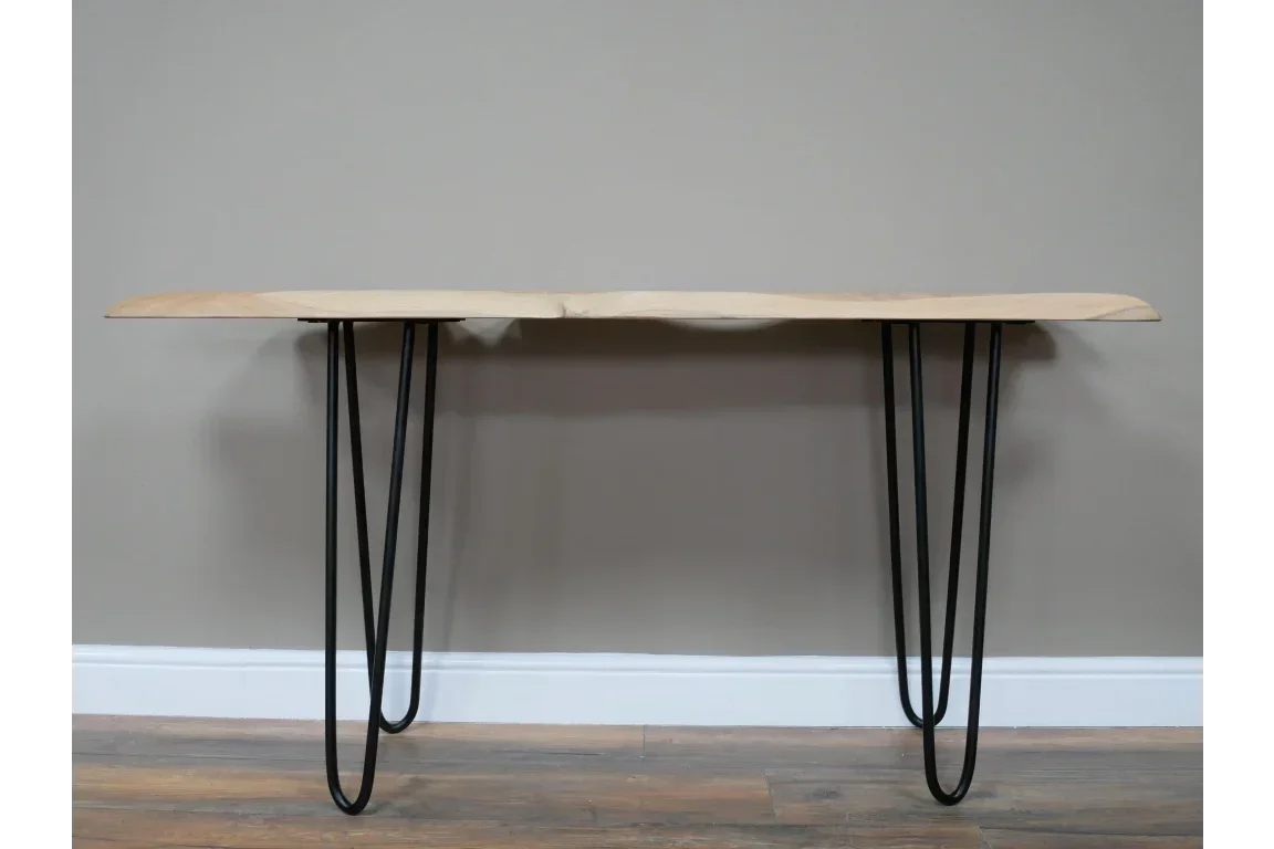Wood console table with natural edge and black metal hairpin legs against grey wall