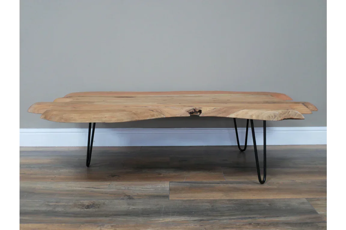 Live edge wood coffee table with metal hairpin legs on wood flooring