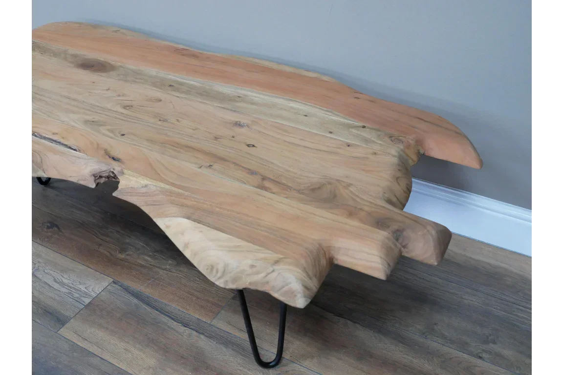 Live edge wooden coffee table with hairpin legs on hardwood floor