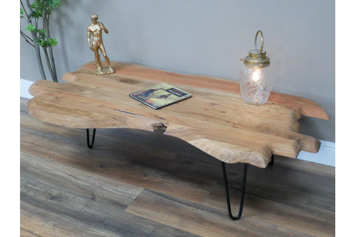 Live edge wooden coffee table with metal hairpin legs in living room setting