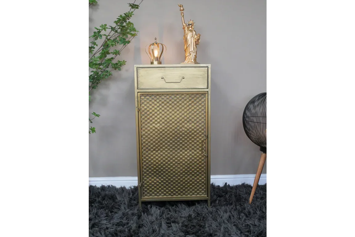 Gold metal cabinet with textured door and single drawer in modern living room setting