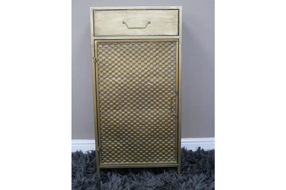 Gold metal cabinet with textured door and single drawer on grey rug